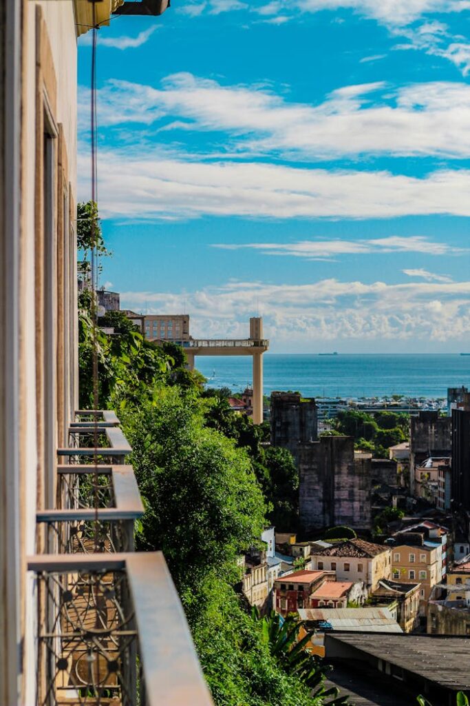 A balcony overlooking the ocean and city